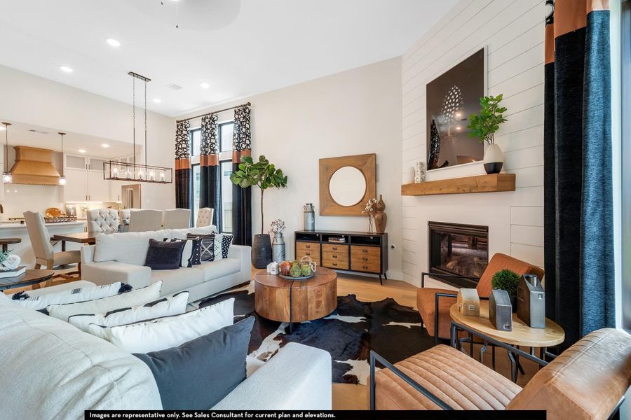 Living area featuring a large fireplace, wood finished floors, and recessed lighting Living area featuring a large fireplace, wood finished floors, and recessed lighting