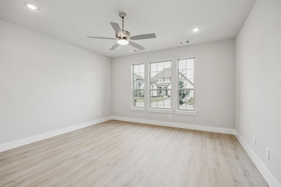 Spare room with light wood-style floors, recessed lighting, and ceiling fan Spare room with light wood-style floors, recessed lighting, and ceiling fan