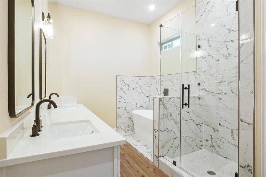 Bathroom featuring independent shower and bath, hardwood / wood-style flooring, and vanity