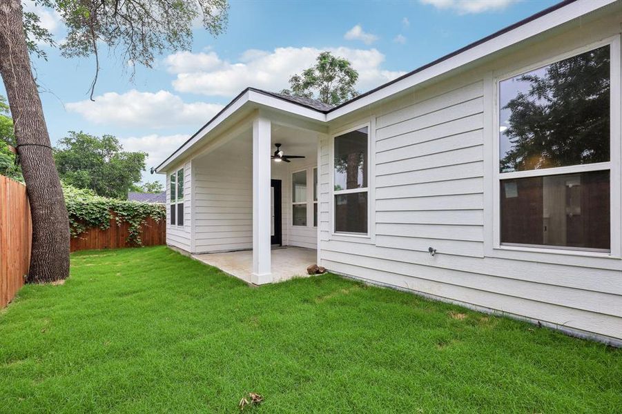 Back of property featuring a ceiling fan and a patio Back of property featuring a ceiling fan and a patio