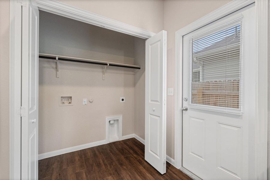 Washroom featuring hookup for a gas dryer, hookup for an electric dryer, dark wood-type flooring, and washer hookup