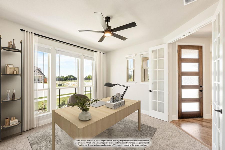 Home office with wood desk, ceiling fan, large windows, and French doors leading to entryway Home office with wood desk, ceiling fan, large windows, and French doors leading to entryway