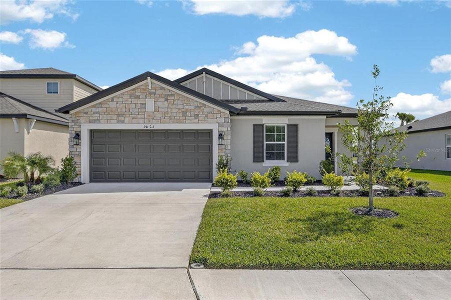 Front exterior of a new home in Summerwoods, Parrish, FL, highlighting curb appeal (Image 25).