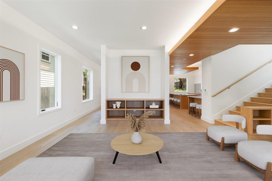 Living room featuring recessed lighting, stairs, and light wood finished floors Living room featuring recessed lighting, stairs, and light wood finished floors