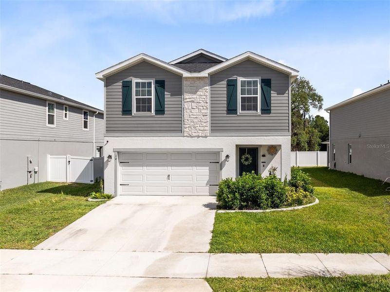 Front exterior of a new home in Siena Reserve, St. Cloud, FL, highlighting curb appeal (Image 19).