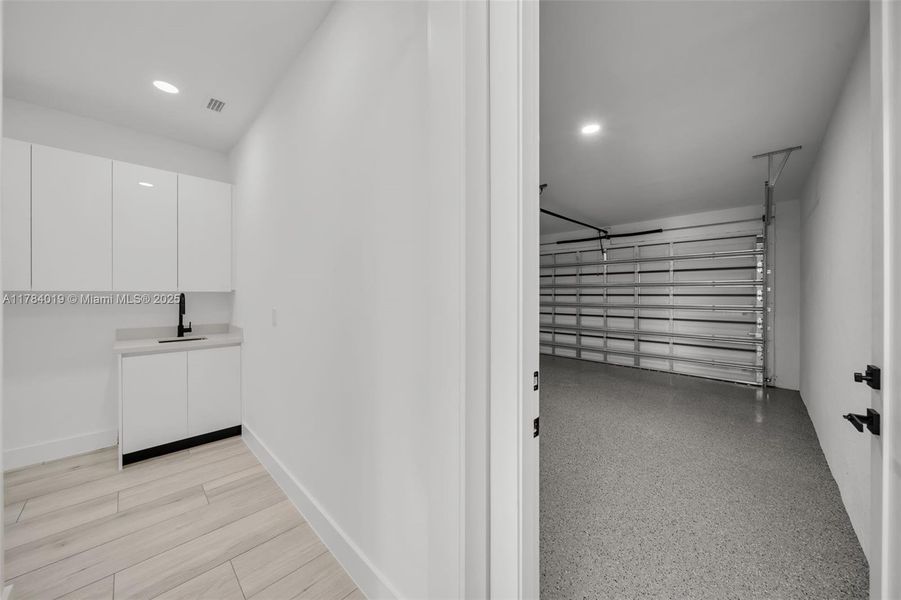 Laundry room between kitchen and garage