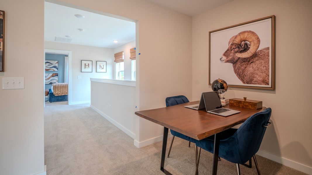 Loft area with opening to hallway leading to staircase