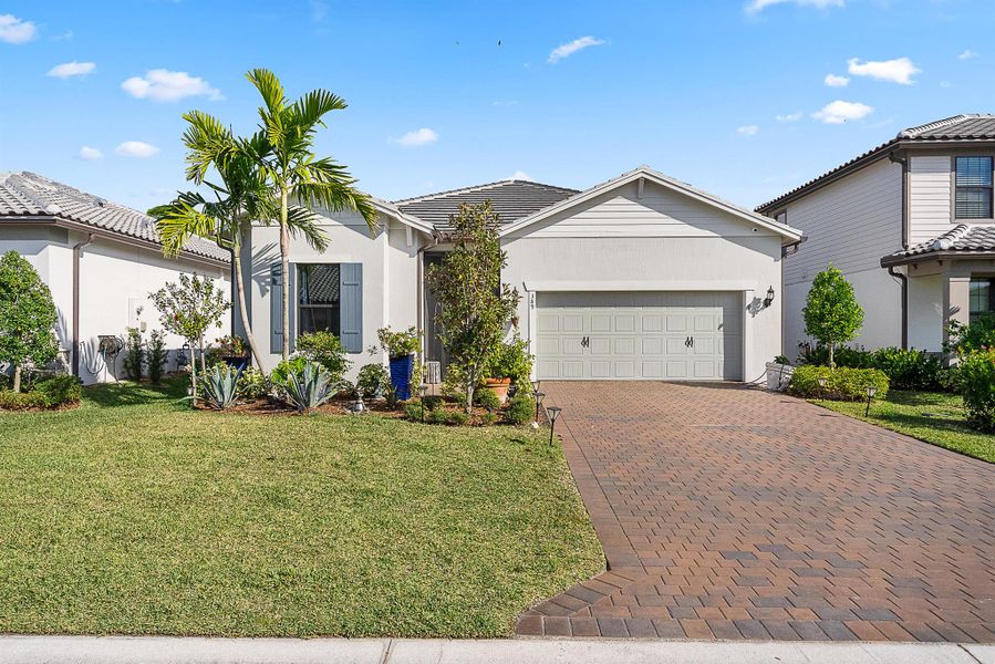 Front exterior of a new home in Veranda Gardens, Port St. Lucie, FL, highlighting curb appeal (Image 1). Front exterior of a new home in Veranda Gardens, Port St. Lucie, FL, highlighting curb appeal (Image 1).