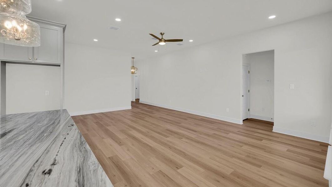 Unfurnished living room featuring light wood finished floors, recessed lighting, and a ceiling fan