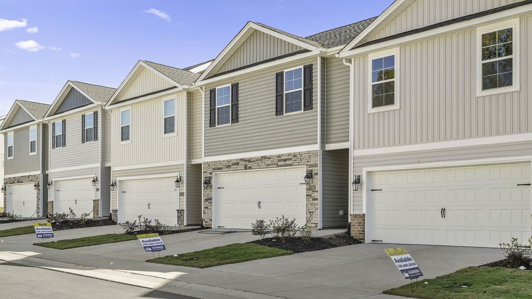 Front exterior of a new home in Brightwood Farm, Whitsett, NC, highlighting curb appeal (Image 2). Front exterior of a new home in Brightwood Farm, Whitsett, NC, highlighting curb appeal (Image 2).