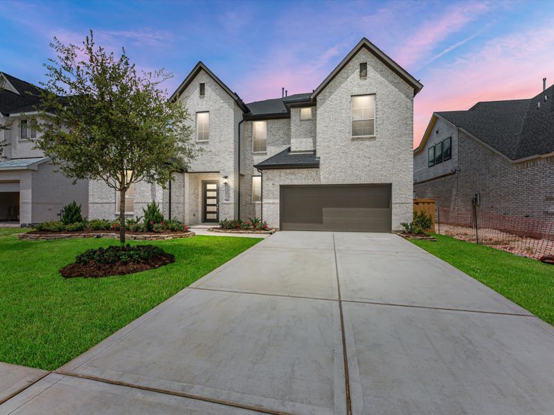 Front exterior of a new home in Dunham Pointe, Cypress, TX, highlighting curb appeal (Image 1). Front exterior of a new home in Dunham Pointe, Cypress, TX, highlighting curb appeal (Image 1).