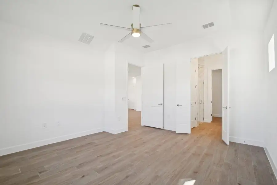 Unfurnished bedroom featuring light wood-style floors and a ceiling fan