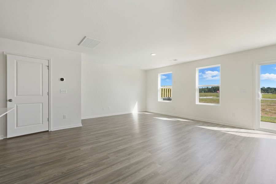A room with white doors and a wood floor.