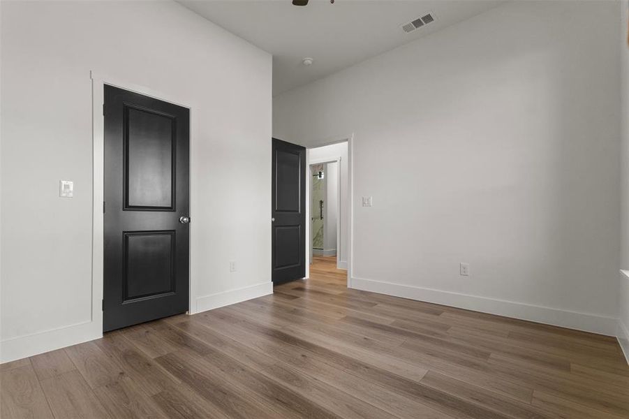 Unfurnished bedroom featuring wood finished floors and ceiling fan