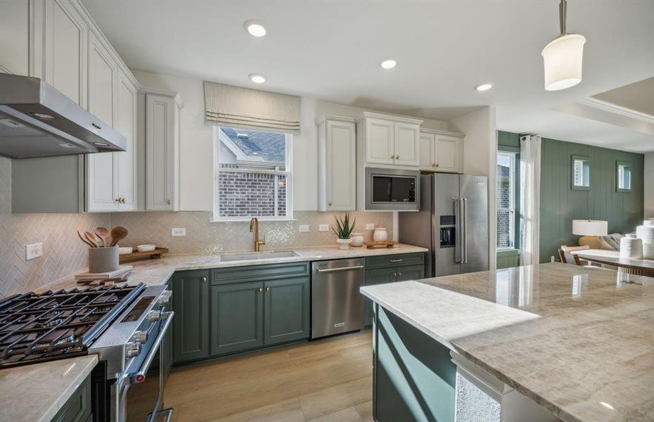 Bright kitchen with an expansive center island perfect for gatherings *Model representation