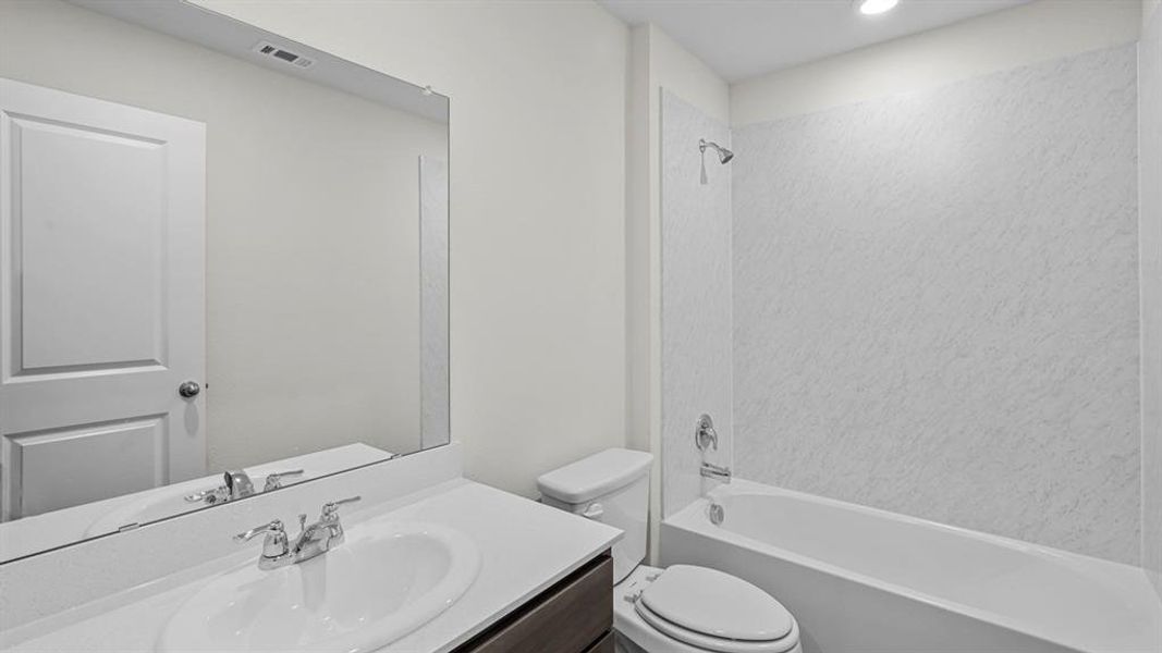 Full bathroom featuring vanity, shower / bathtub combination, and recessed lighting