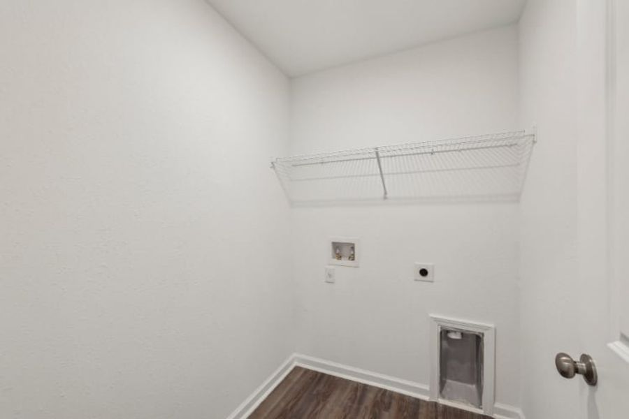 A room with a vent and a wood floor.