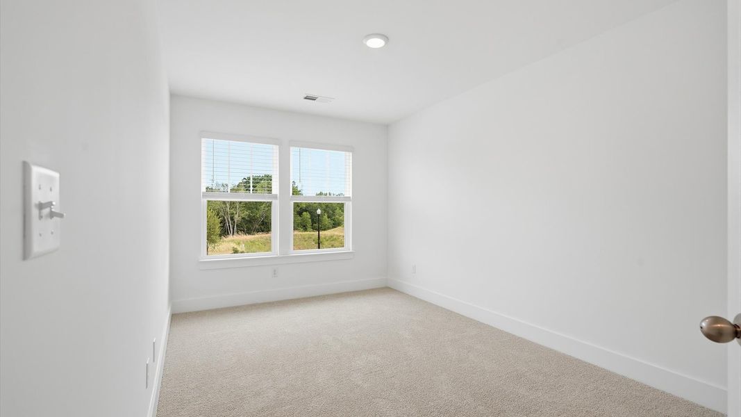 First-class bedroom with generous proportions, a walk-in closet, and beautiful natural light through large windows in SC First-class bedroom with generous proportions, a walk-in closet, and beautiful natural light through large windows in SC