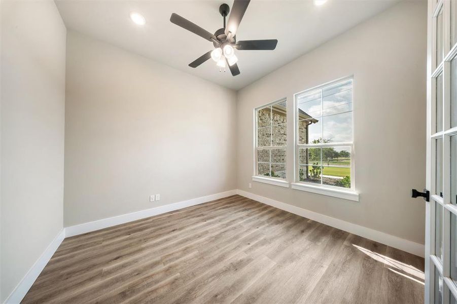 Unfurnished room with wood finished floors, recessed lighting, and a ceiling fan Unfurnished room with wood finished floors, recessed lighting, and a ceiling fan