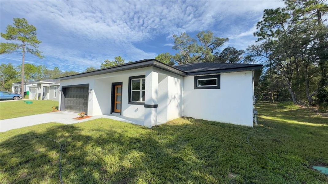 Front exterior of a new home in , Citrus Springs, FL, highlighting curb appeal (Image 2). Front exterior of a new home in , Citrus Springs, FL, highlighting curb appeal (Image 2).