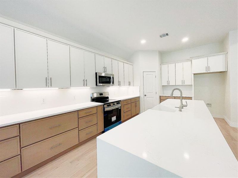 The beautiful, sparkling waterfall counter elevates the kitchen to a different level of elegance