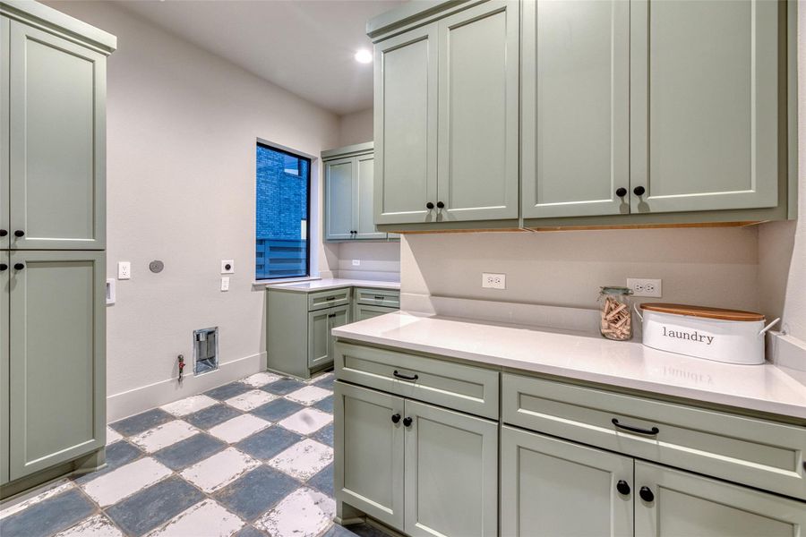 Huge laundry room with lots of storage and two folding counters Huge laundry room with lots of storage and two folding counters