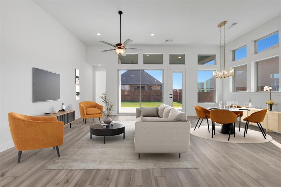 Open-concept living space featuring wood-finish flooring, high ceilings, and recessed lighting Open-concept living space featuring wood-finish flooring, high ceilings, and recessed lighting