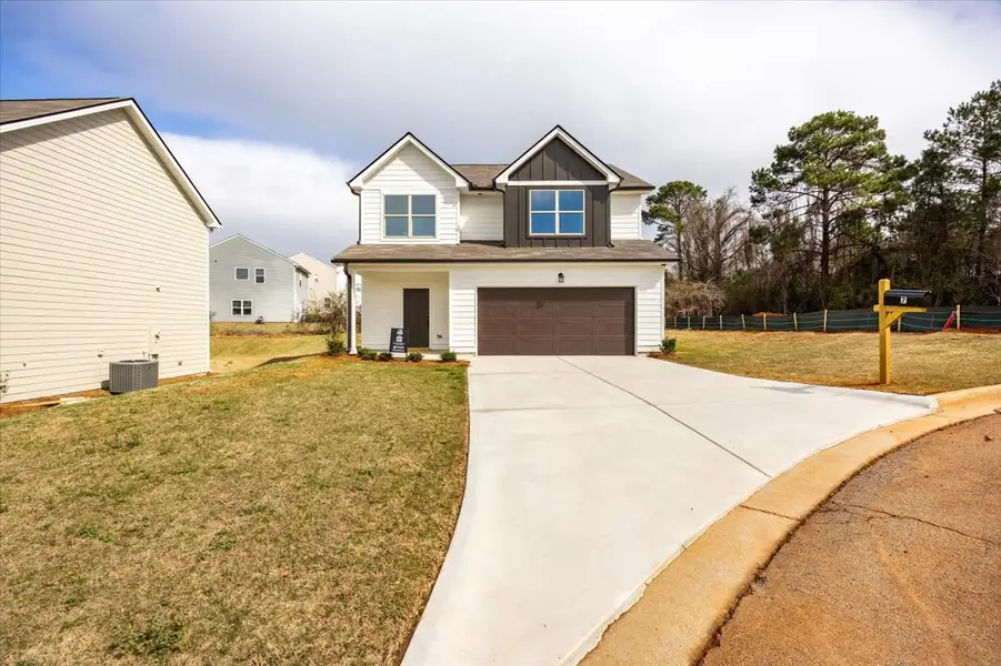 Front exterior of a new home in Creekside Manor, Thomaston, GA, highlighting curb appeal (Image 14). Front exterior of a new home in Creekside Manor, Thomaston, GA, highlighting curb appeal (Image 14).