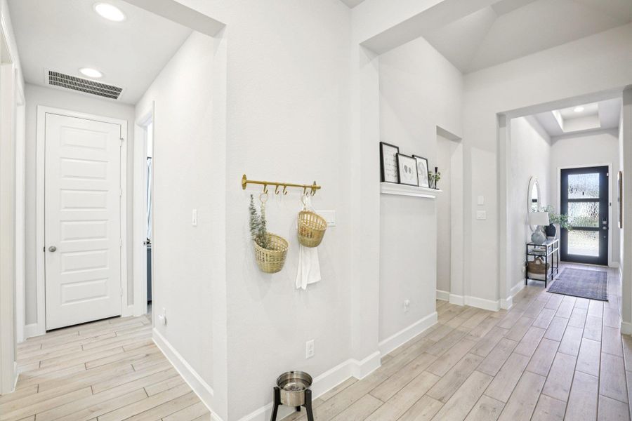 Corridor featuring wood finish floors and recessed lighting