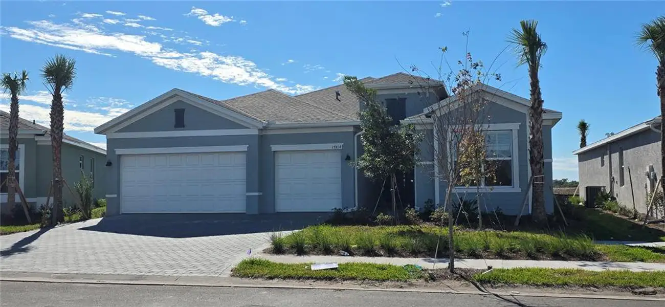 Front exterior of a new home in Rye Ranch: Manor Homes, Parrish, FL, highlighting curb appeal (Image 2).