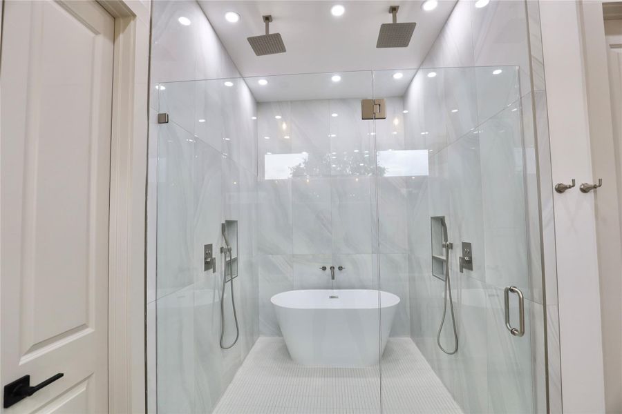 Recessed ceiling lights enhance the spa-like ambiance, creating a tranquil atmosphere while showering. Recessed ceiling lights enhance the spa-like ambiance, creating a tranquil atmosphere while showering.
