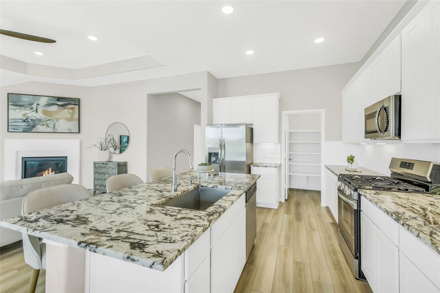 Chef’s kitchen equipped with a gas burner, sleek granite countertops, and premium tile backsplash.