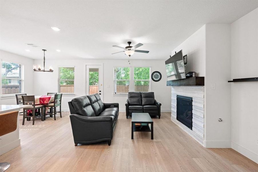 Living area featuring light wood-finish flooring, recessed lighting, and a ceiling fan Living area featuring light wood-finish flooring, recessed lighting, and a ceiling fan