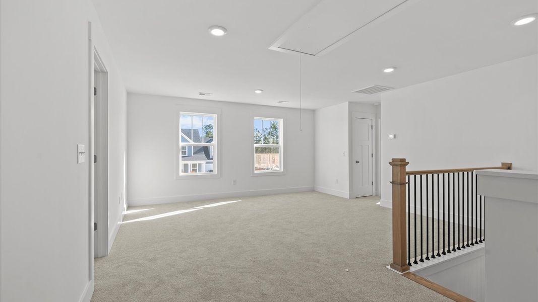 Inviting loft with cozy carpet, perfect for casual gatherings or quiet relaxation