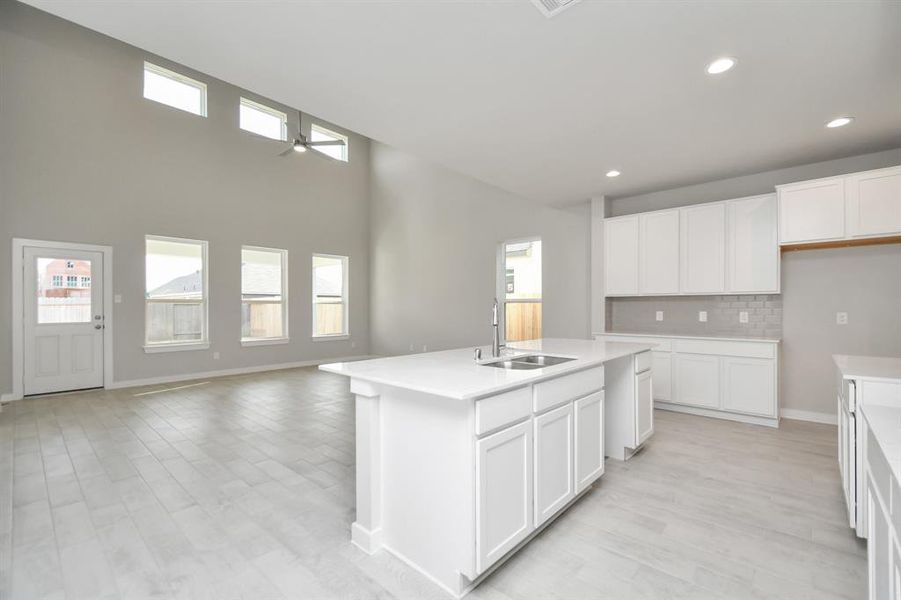 All of this overlooks your expansive family room, creating a perfect space for culinary delights and family gatherings. Sample photo of completed home with similar floor plan. As-built interior colors and selections may vary.