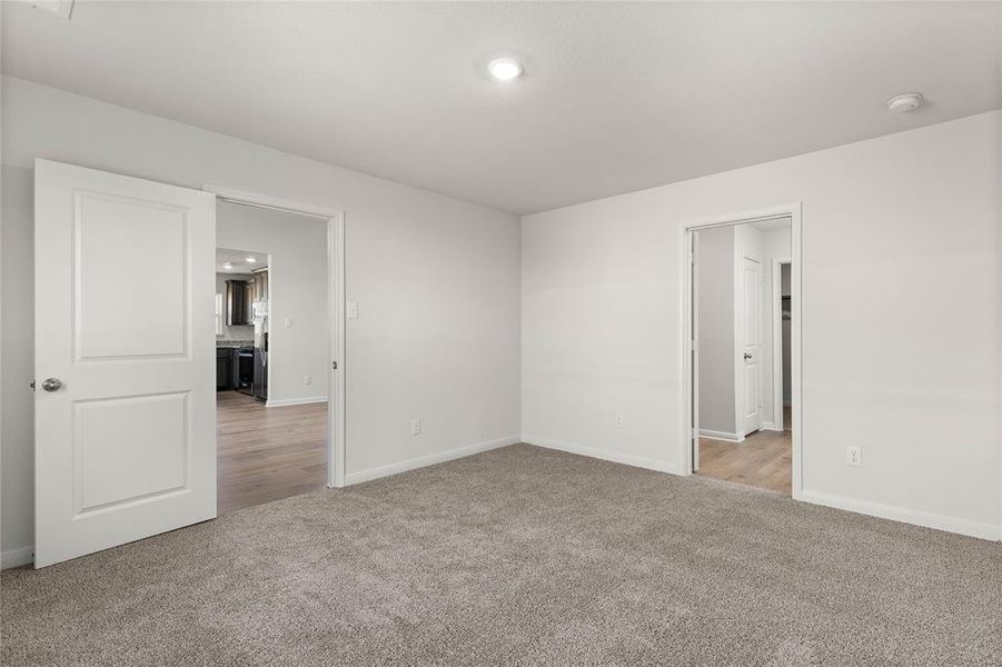 Spare room with light colored carpet and recessed lighting Spare room with light colored carpet and recessed lighting