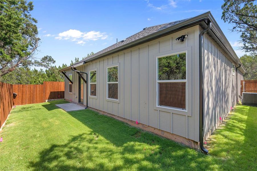 Rear view of house with a yard