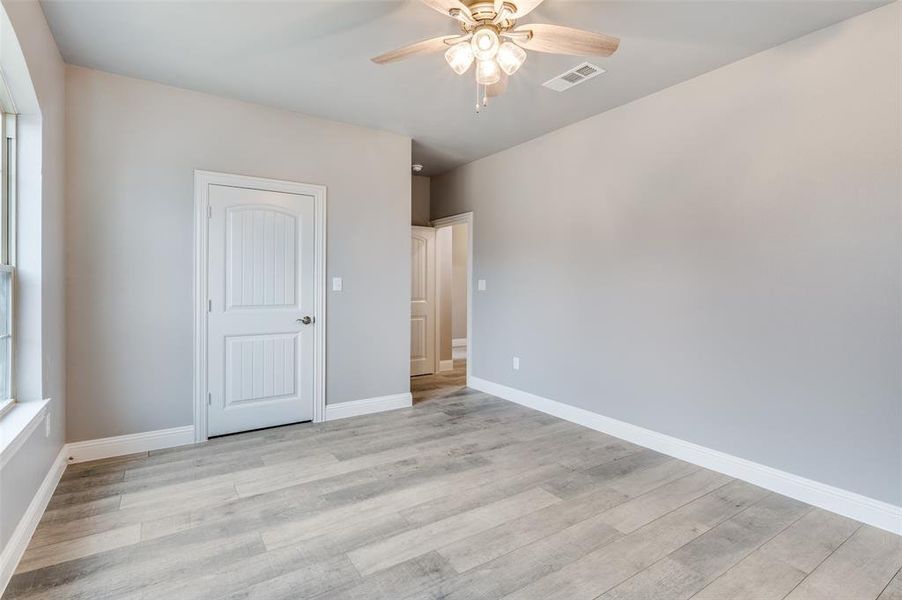 Unfurnished bedroom featuring ceiling fan and light wood-type flooring