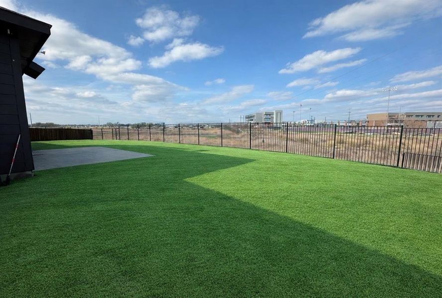Fenced backyard featuring a patio