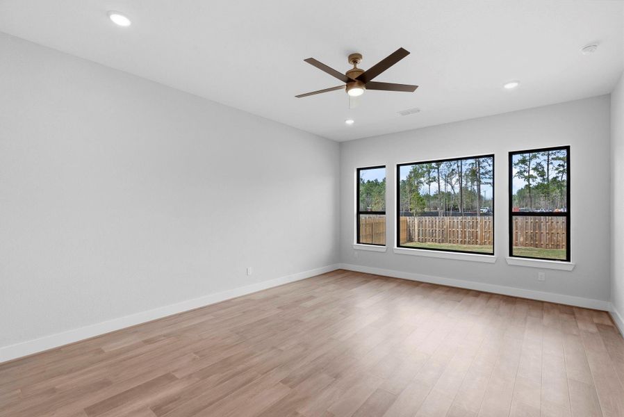 Primary bedroom with large windows creating tons of natural light
