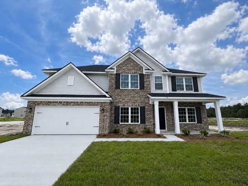 Front exterior of a new home in Doctor's Creek, Ludowici, GA, highlighting curb appeal (Image 1). Front exterior of a new home in Doctor's Creek, Ludowici, GA, highlighting curb appeal (Image 1).