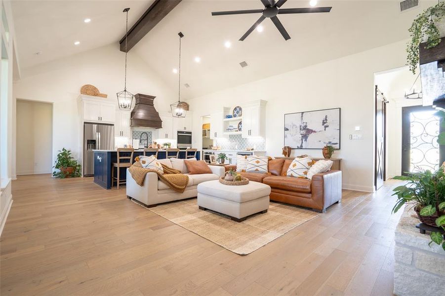 Living room featuring light wood finished floors, a ceiling fan, and recessed lighting Living room featuring light wood finished floors, a ceiling fan, and recessed lighting