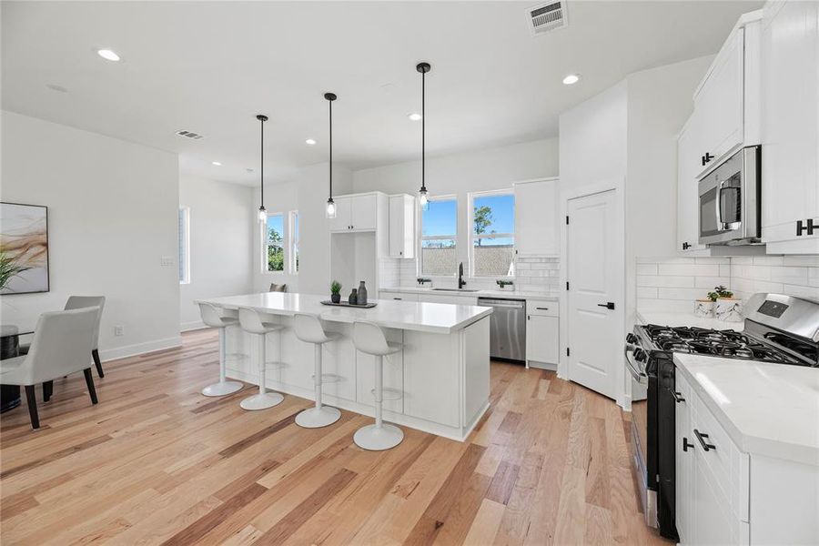 The island is full of deep drawers for storage, all the cabinetry was built on site and features soft close drawers and under cabinet lighting.