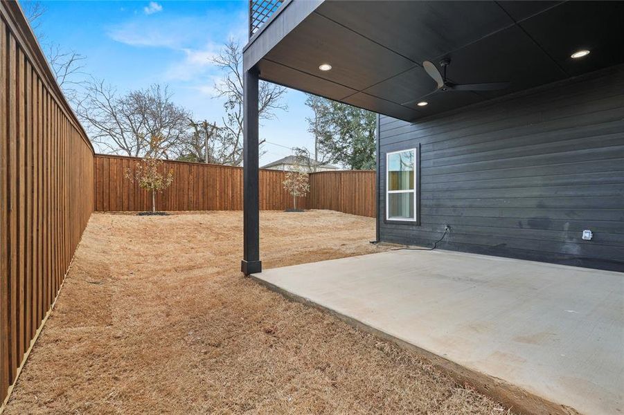 Fenced backyard with a patio area and ceiling fan Fenced backyard with a patio area and ceiling fan