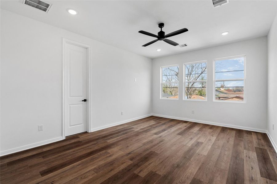 Upstairs retreat with generous space, large windows, and a walk-in closet for comfort and functionality.