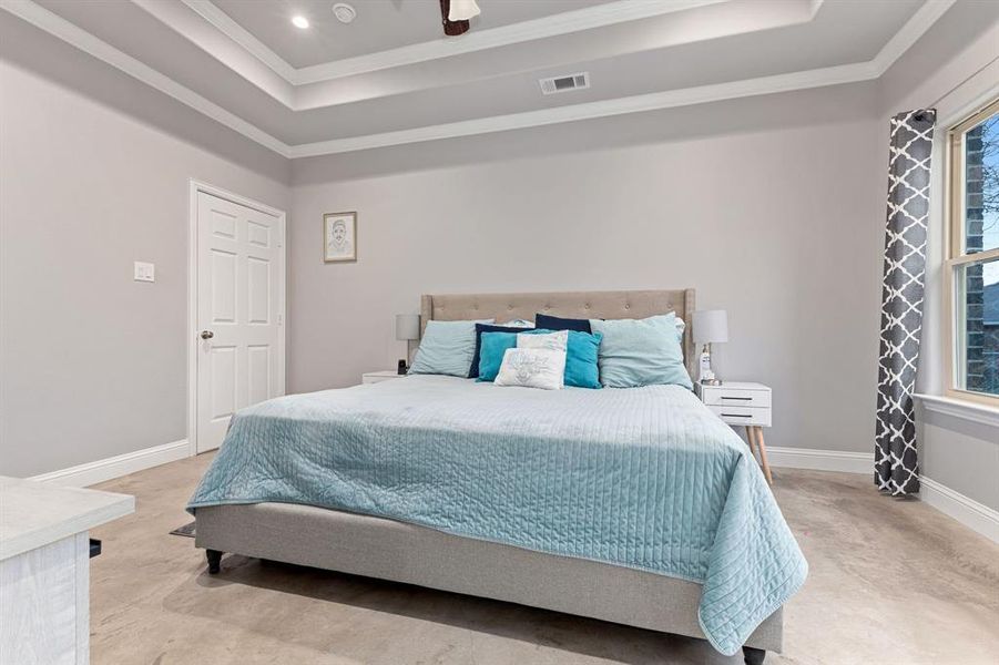 Bedroom featuring ornamental molding and a raised ceiling