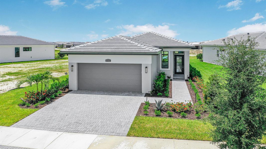 Front exterior of a new home in PGA Village Verano, Port St. Lucie, FL, highlighting curb appeal (Image 1). Front exterior of a new home in PGA Village Verano, Port St. Lucie, FL, highlighting curb appeal (Image 1).