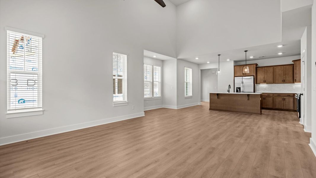 Exceptional family space featuring two-story ceilings, hardwood flooring, and tasteful finishes throughout