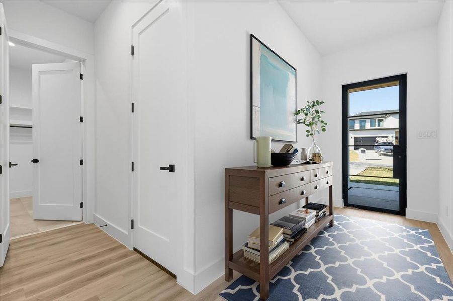 Foyer entrance featuring light wood-style floors and baseboards Foyer entrance featuring light wood-style floors and baseboards