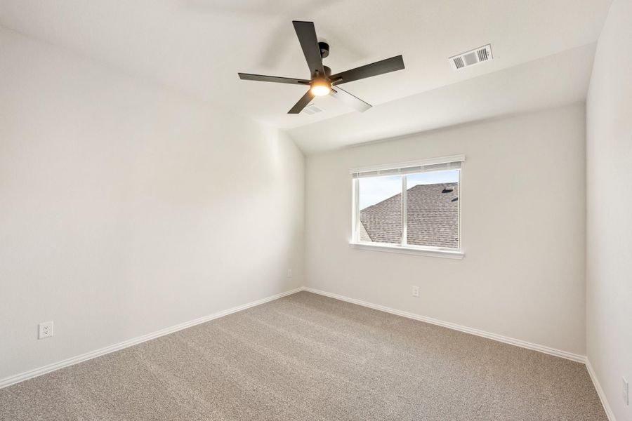 Empty bedroom with vaulted ceiling, ceiling fan, carpet flooring, and single window